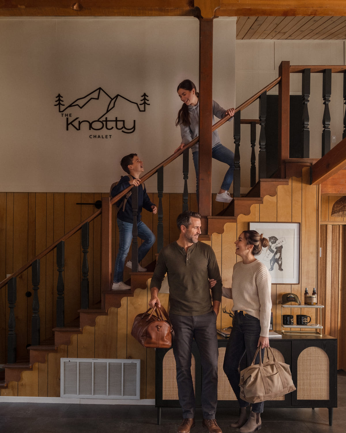 A family arriving under the Knotty Chalet sign
