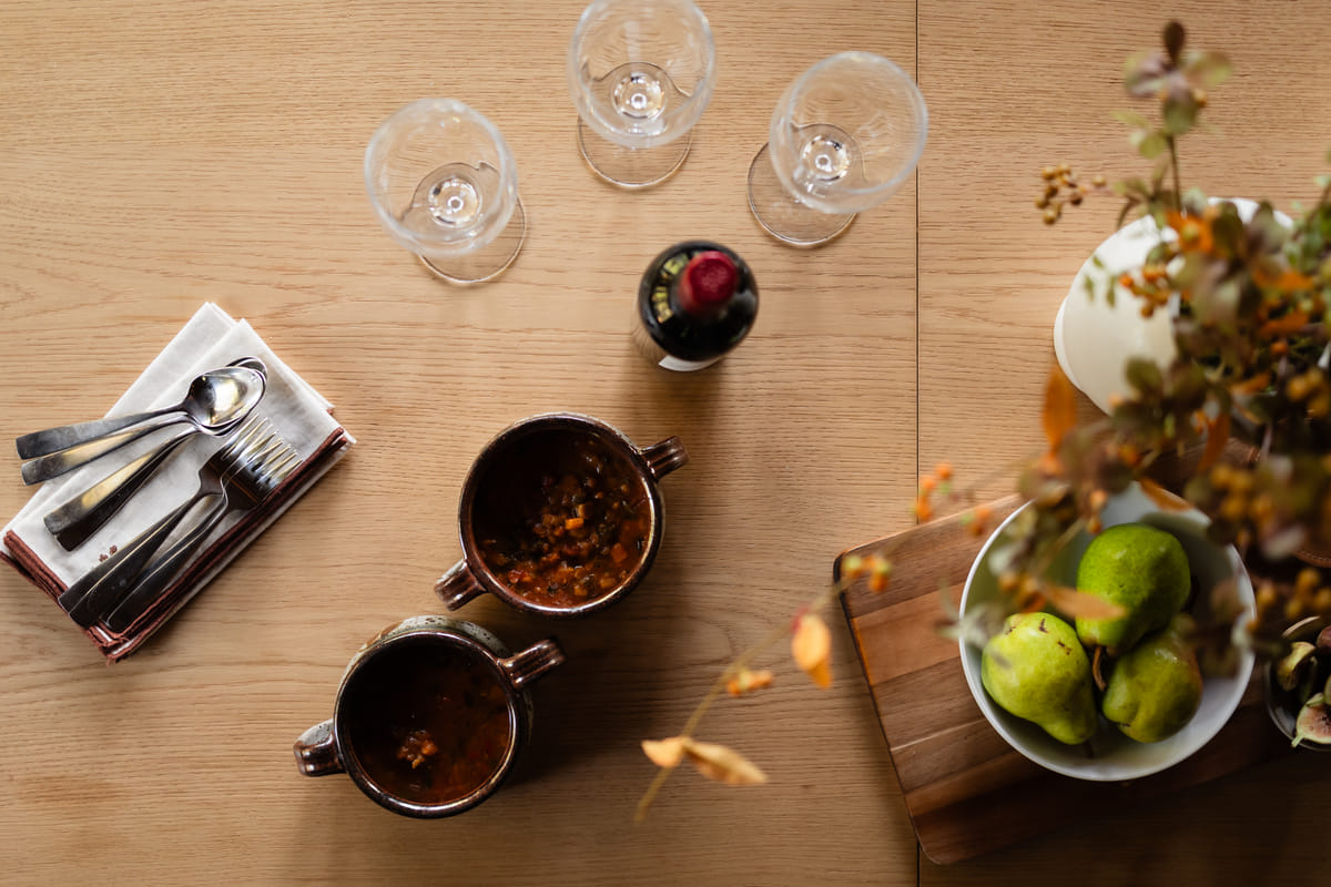 Glasses, bowls and pears on the table from above